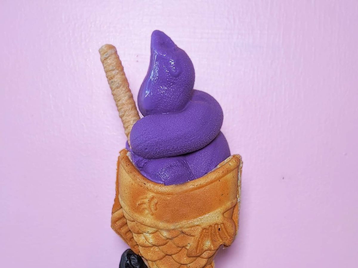 A fish soft-cone with purple soft serve in it.