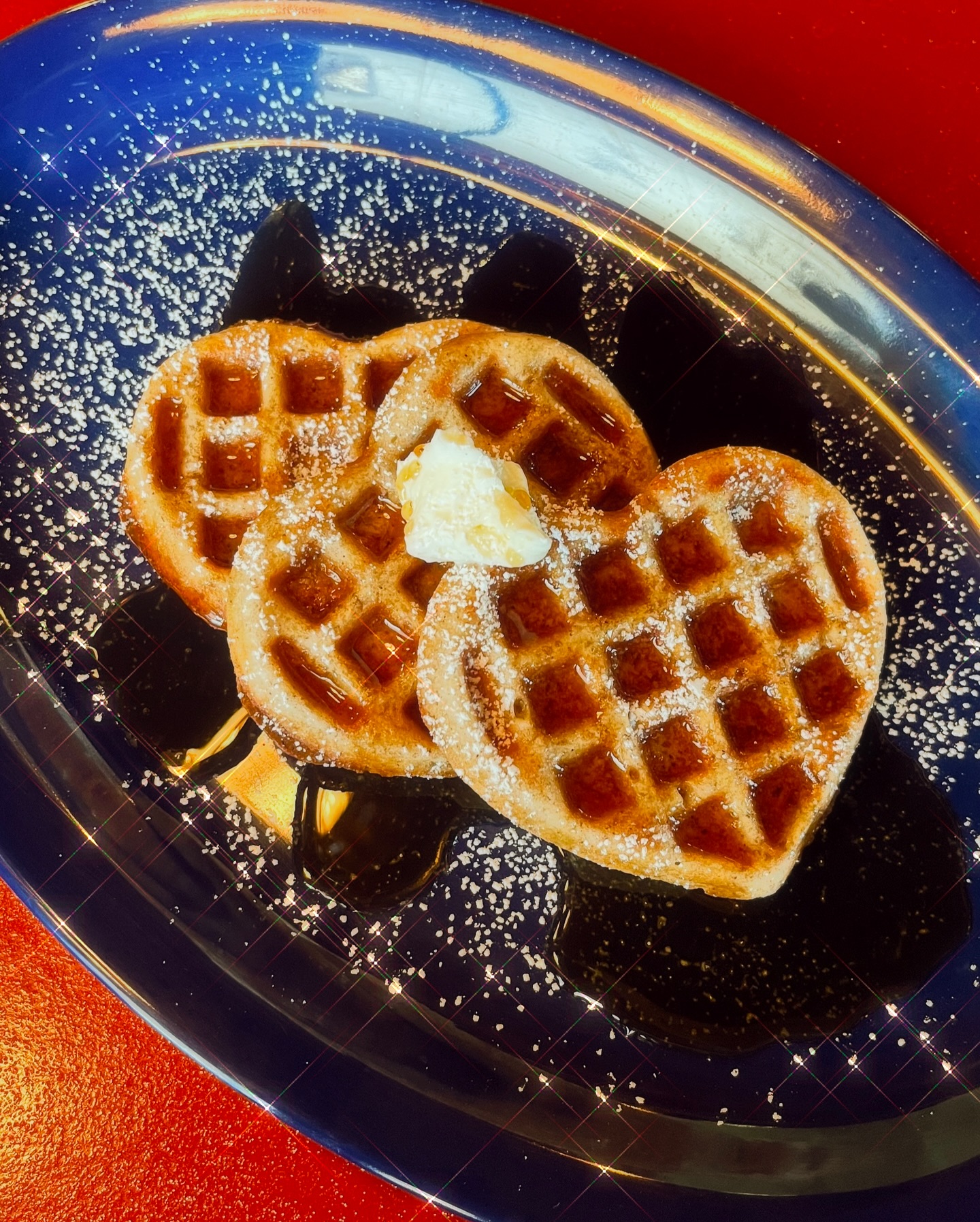 Heart-shaped waffles on a plate.