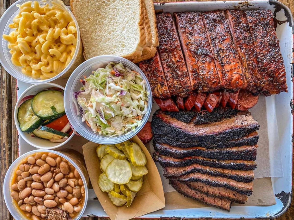 A tray of barbecue meats and sides. 