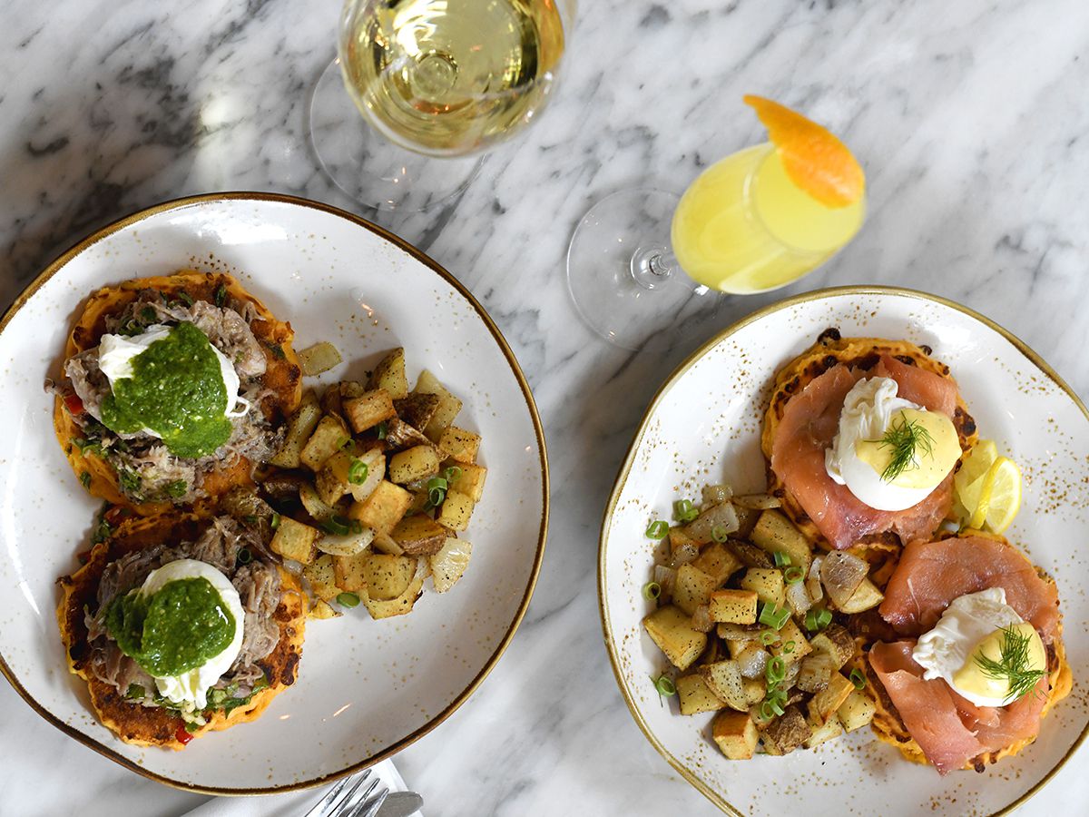 Two plates of eggs benedicts.
