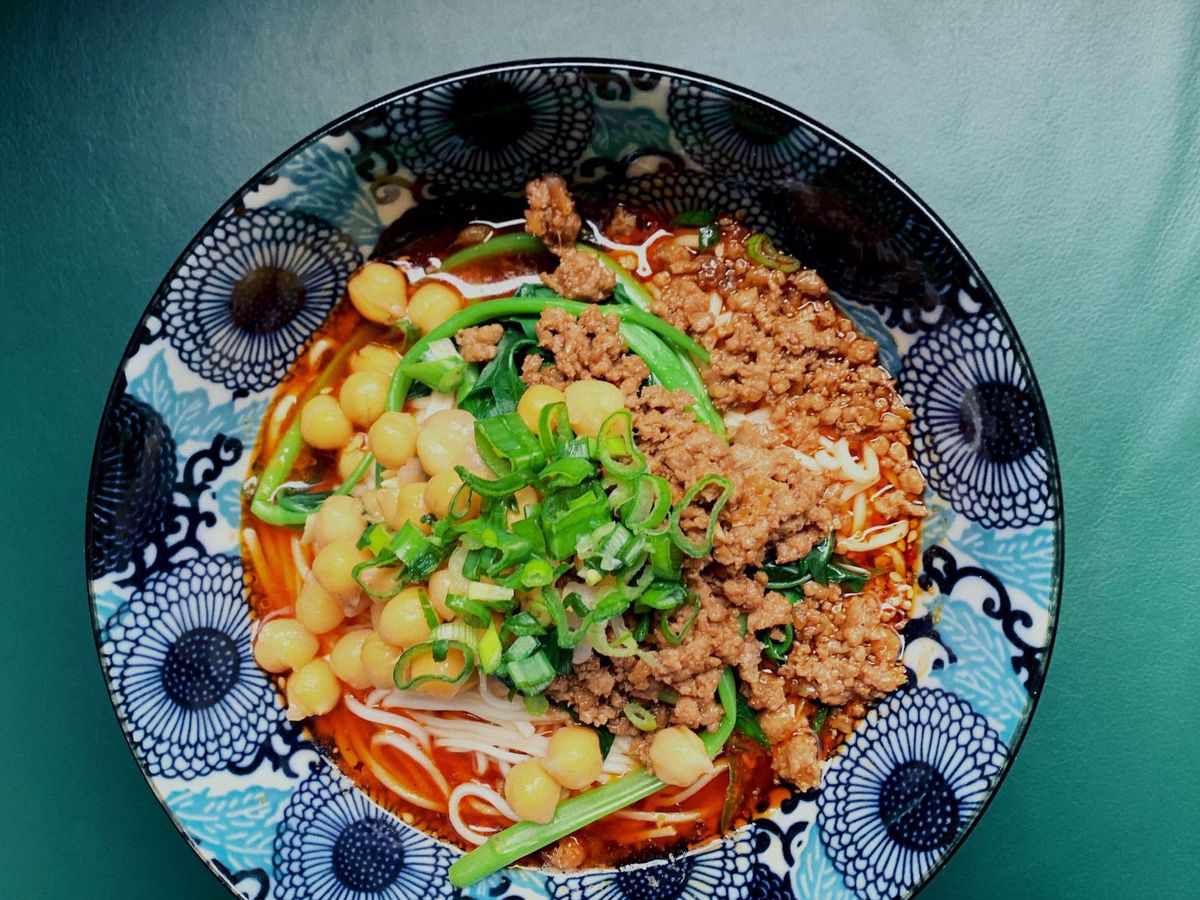 Liu Xiaomian’s spicy numbing noodles in an ornate blue, navy, and white bowl.
