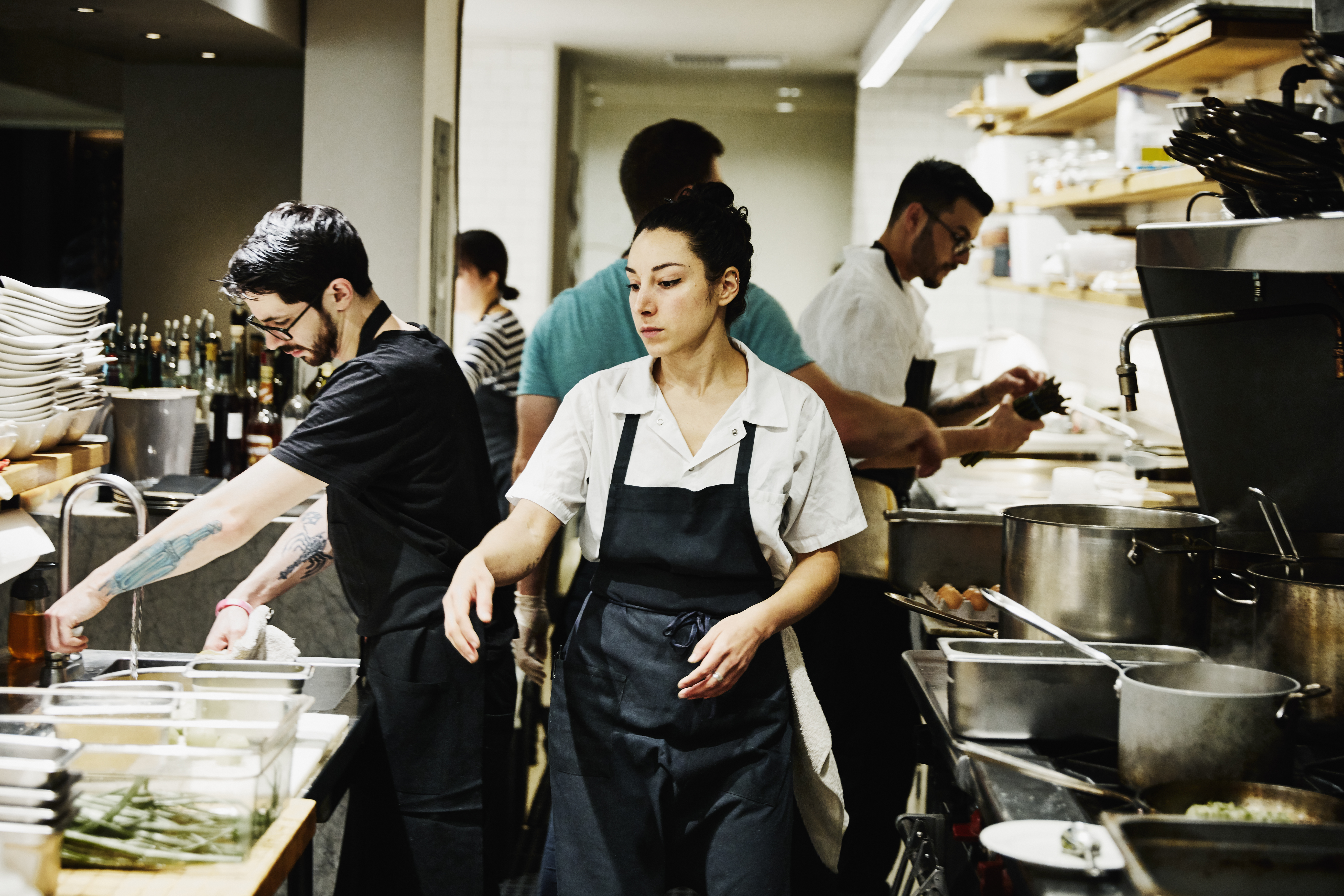 People at work inside a restaurant kitchen 