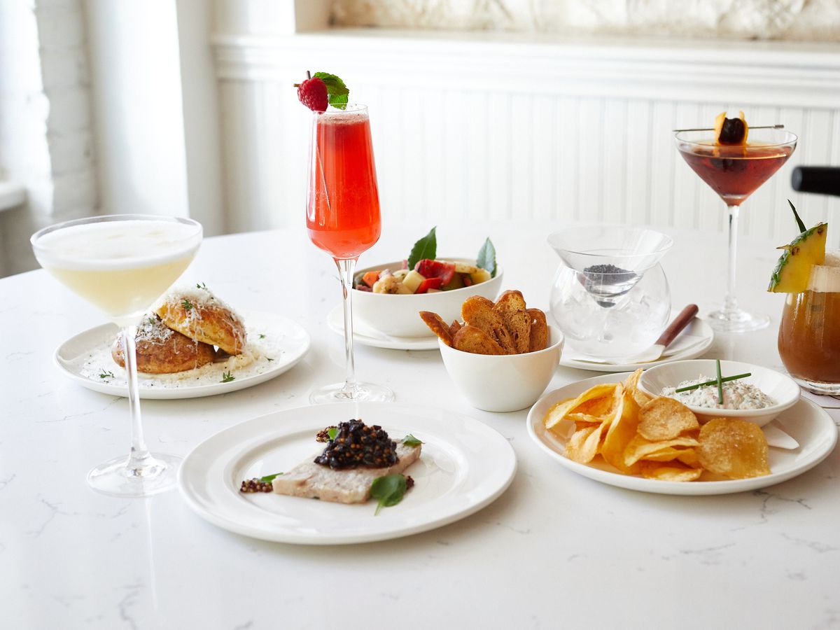 A table of food on plates and drinks in glasses.