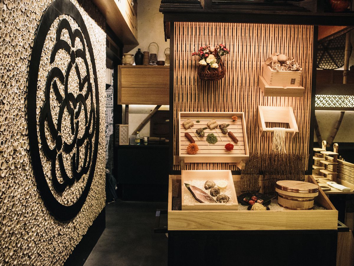 A food cart with dishes in a restaurant.
