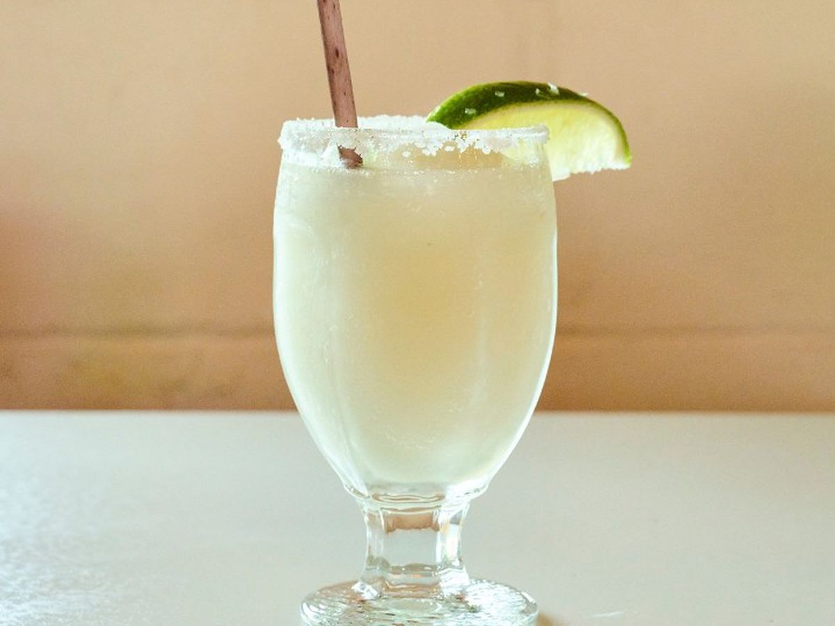 A white frozen cocktail in a large glass.