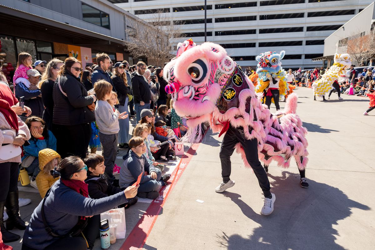 Dancers in a dragon costume perform for a crowd at the Lunar New Year Festival in East Austin.