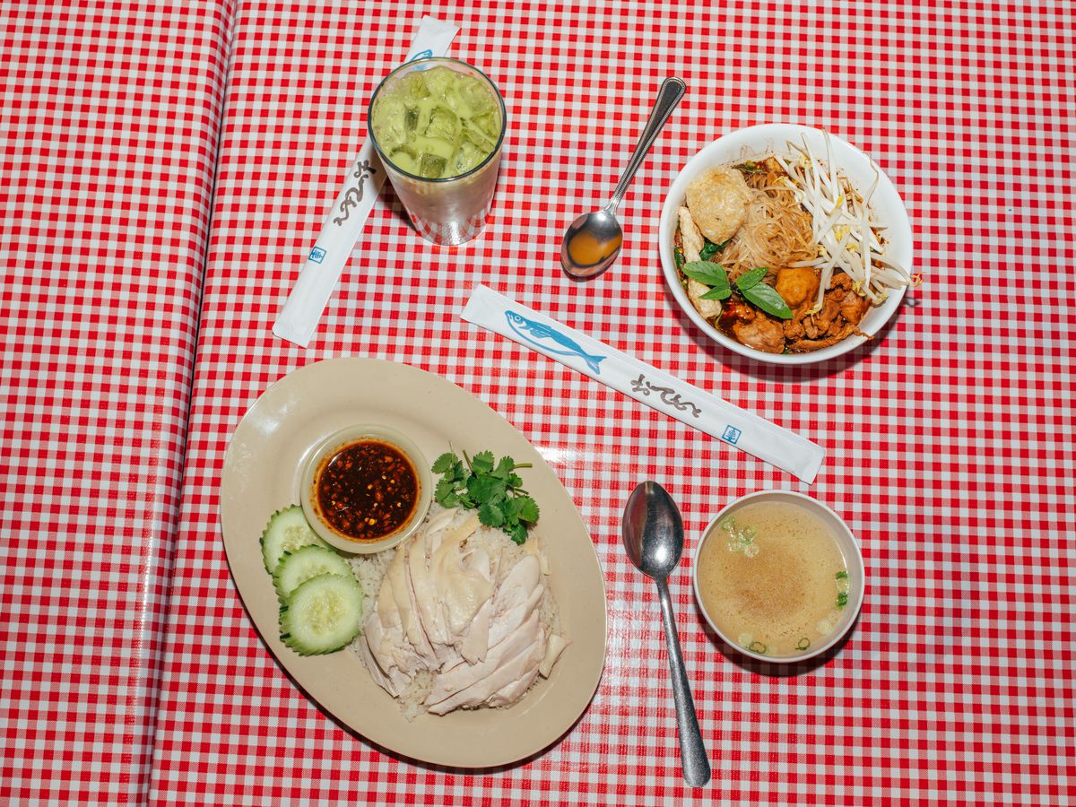 A red-white checkered table with food on plates.