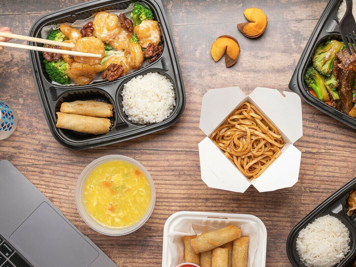A table of food in takeout packages.