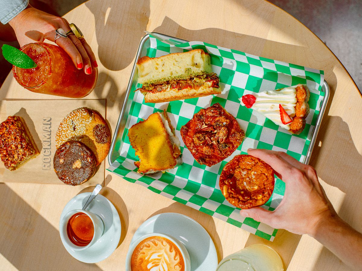 A tray and table full of baked goods.