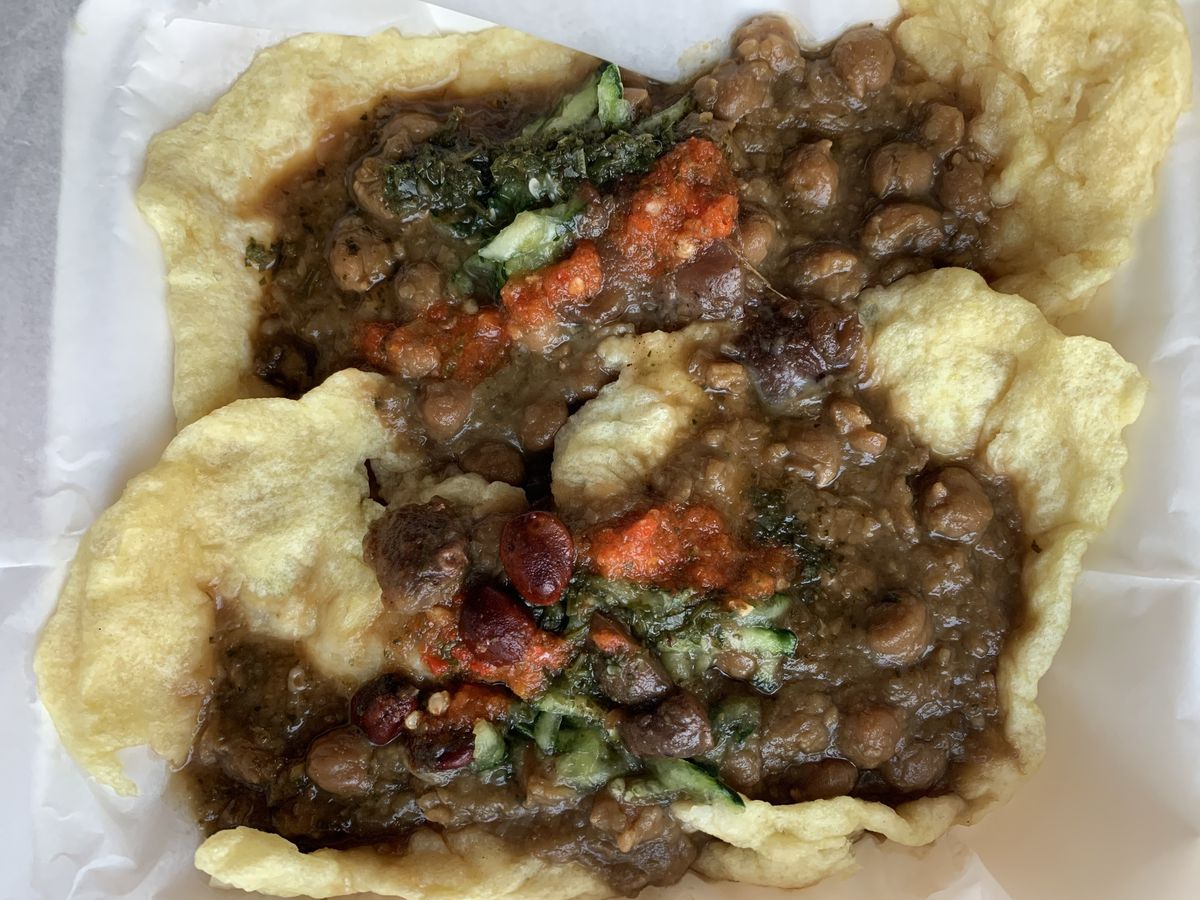 Chickpeas in brown sauce on a bed of crunchy fried bread.
