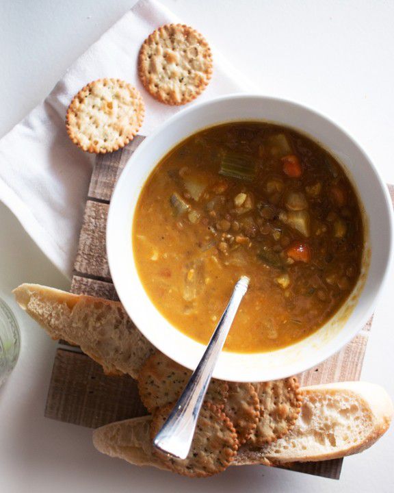 A bowl of bean soup with lots of vegetables.