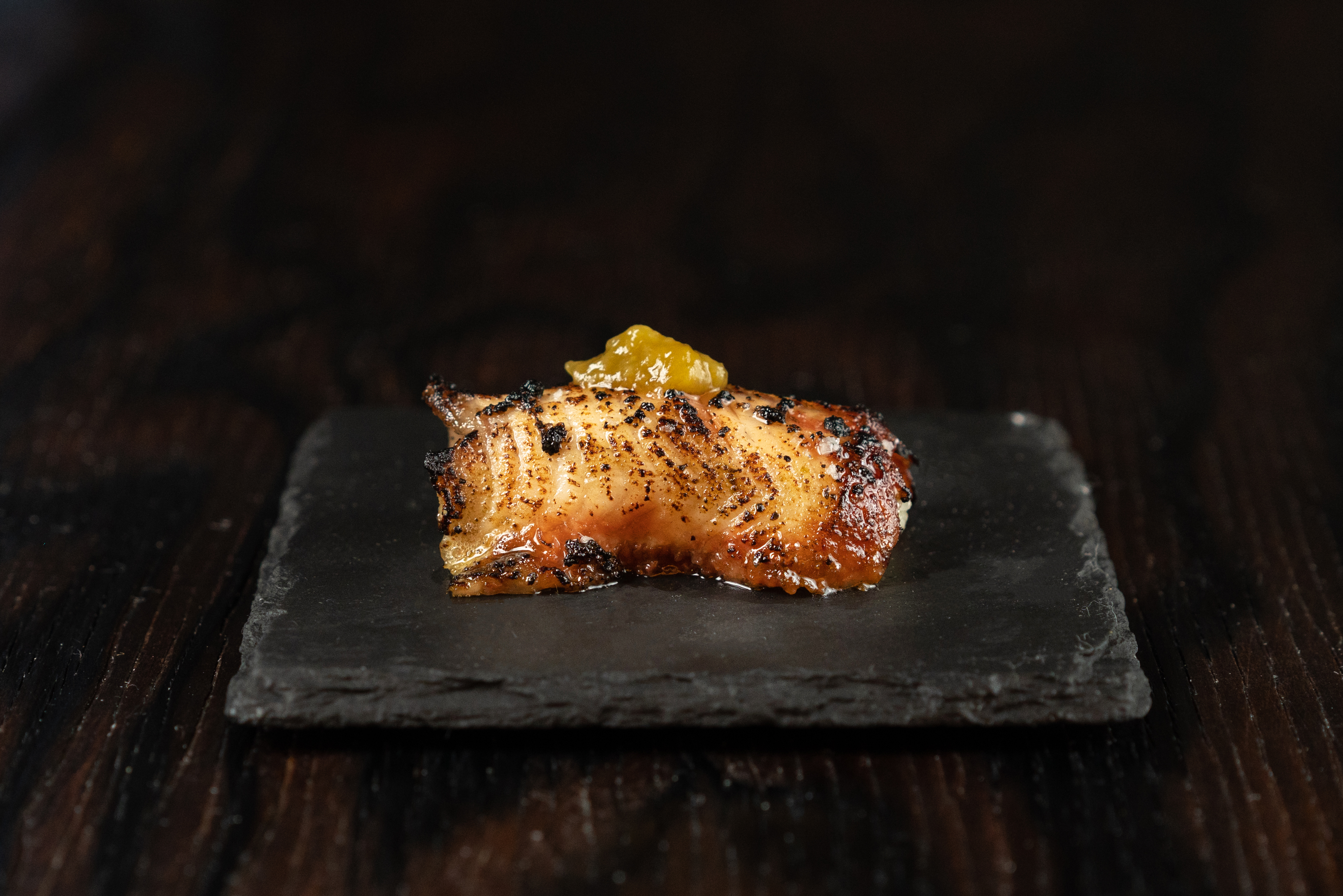 A piece of freshwater eel on a slate.